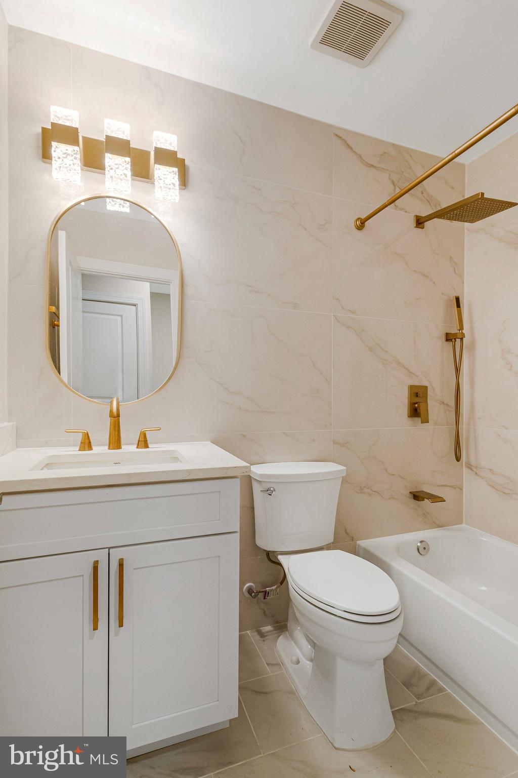 1350 Sheridan Street Northwest Washington, DC 20011 - Photo 27 of 55 a bathroom with a toilet a sink a mirror and vanity