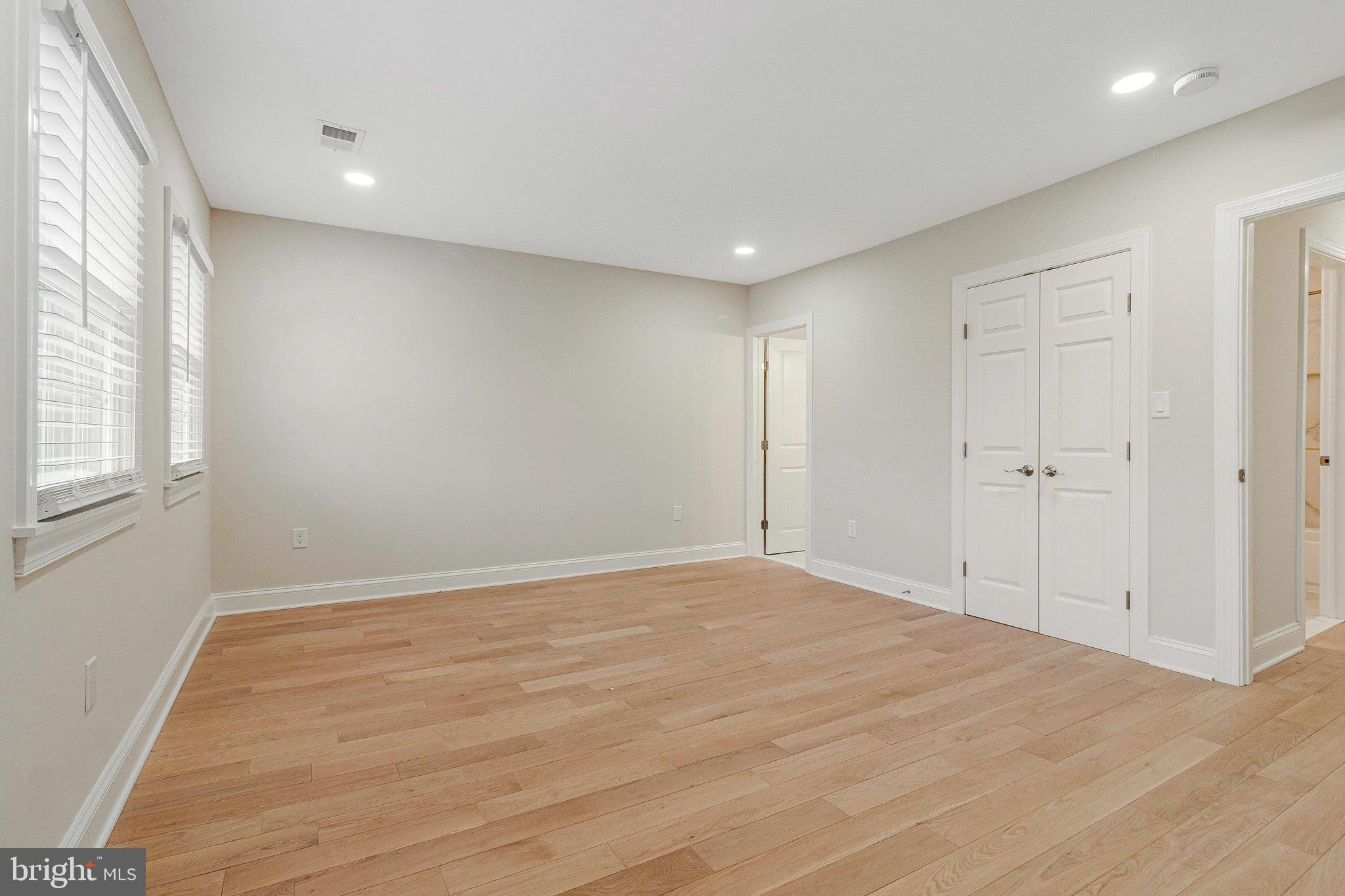 1350 Sheridan Street Northwest Washington, DC 20011 - Photo 32 of 55 a view of an empty room with wooden floor and a window