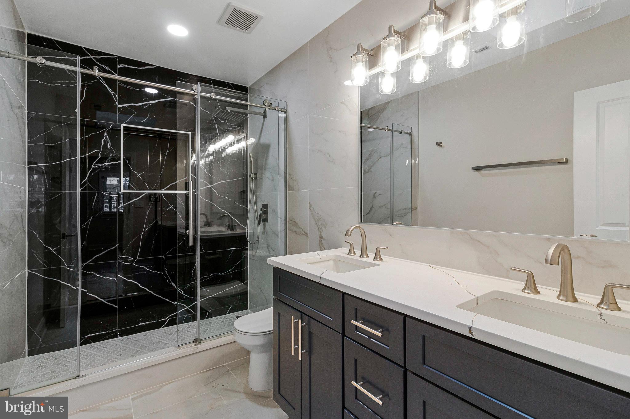 1350 Sheridan Street Northwest Washington, DC 20011 - Photo 33 of 55 a bathroom with a sink a toilet and shower