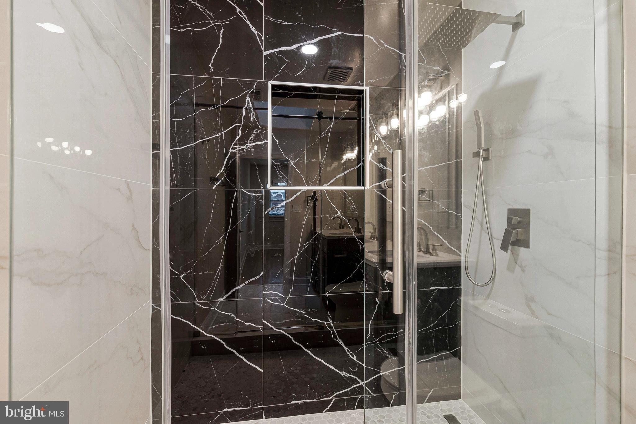 1350 Sheridan Street Northwest Washington, DC 20011 - Photo 35 of 55 a bathroom with a glass shower door