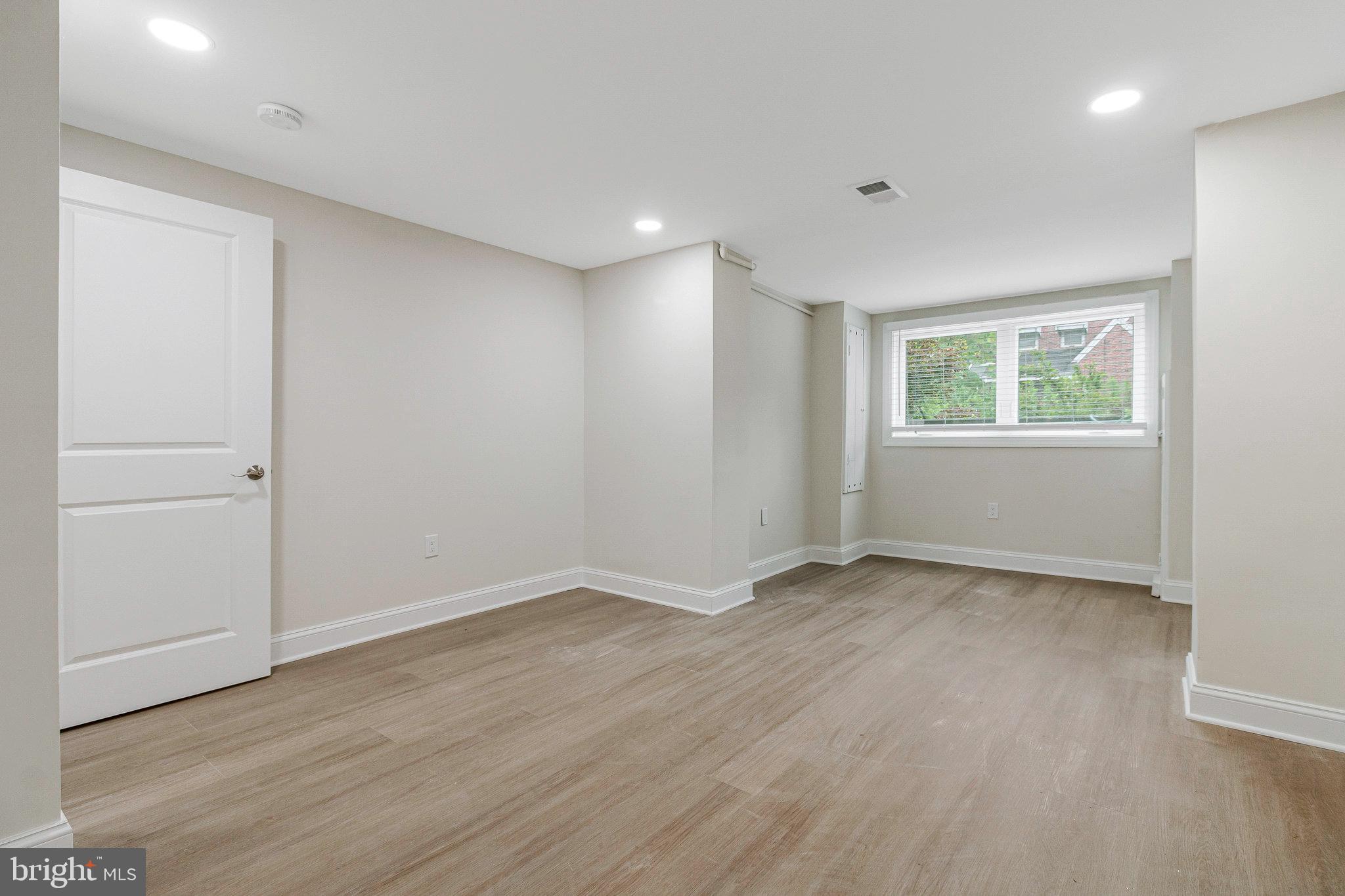 1350 Sheridan Street Northwest Washington, DC 20011 - Photo 41 of 55 an empty room with wooden floor and windows
