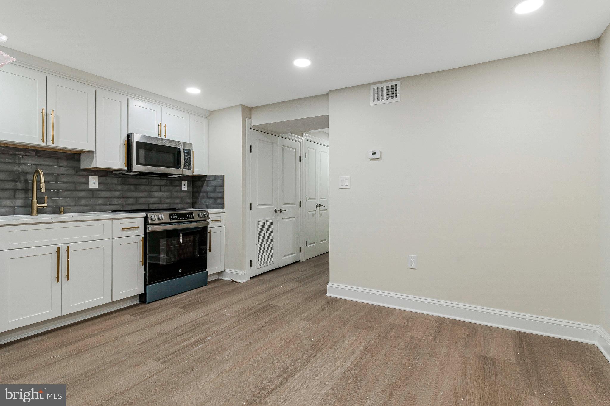 1350 Sheridan Street Northwest Washington, DC 20011 - Photo 43 of 55 a kitchen with a refrigerator and a stove top oven