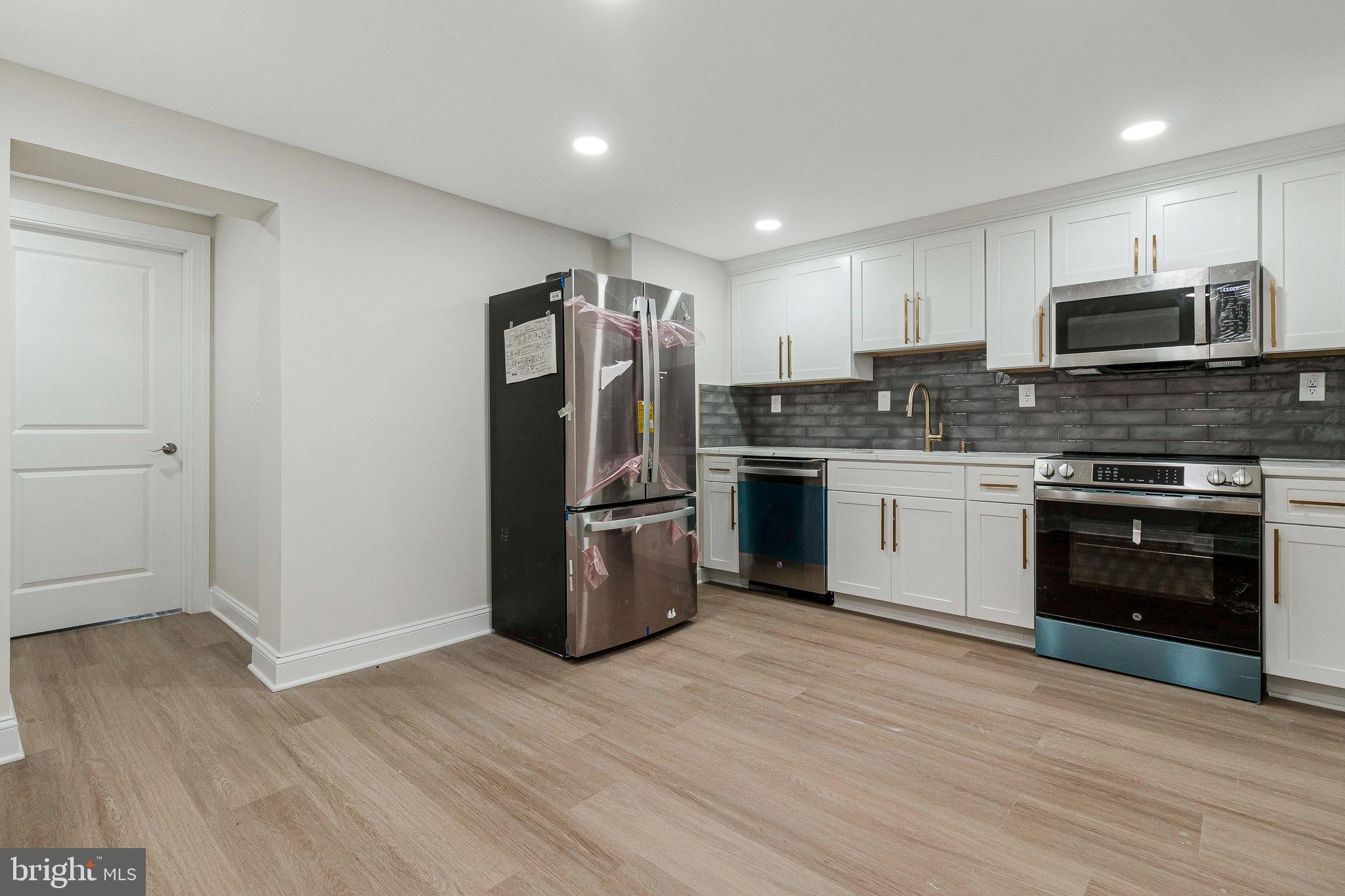 1350 Sheridan Street Northwest Washington, DC 20011 - Photo 44 of 55 a kitchen with stainless steel appliances granite countertop a refrigerator stove and sink