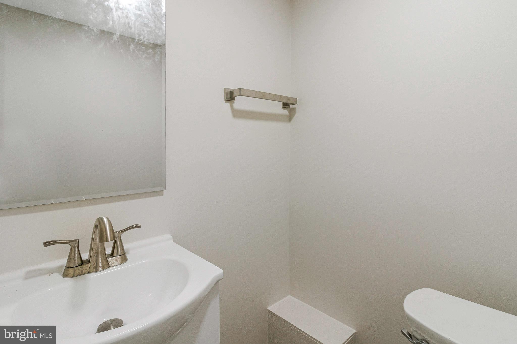 1350 Sheridan Street Northwest Washington, DC 20011 - Photo 48 of 55 a bathroom with a sink a toilet and mirror