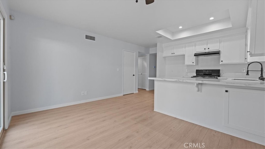 10720 Springfield Drive Rancho Cucamonga, CA 91730 - Photo 12 of 35 a view of a kitchen with white cabinets