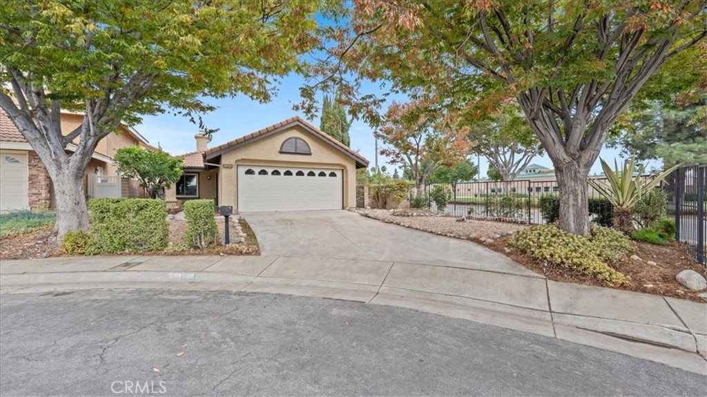 10720 Springfield Drive Rancho Cucamonga, CA 91730 - Photo 2 of 35 a front view of a house with a yard and garage