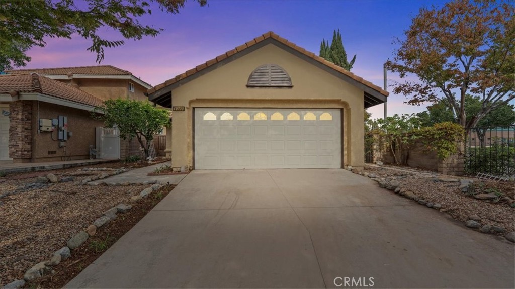 10720 Springfield Drive Rancho Cucamonga, CA 91730 - Photo 34 of 35 a front view of a house with a yard and garage