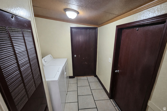 340 West 920 South, Unit 16 Provo, UT 84601 - Photo 13 of 15 Laundry room featuring a heating unit, crown molding, light tile patterned flooring, and washer and clothes dryer