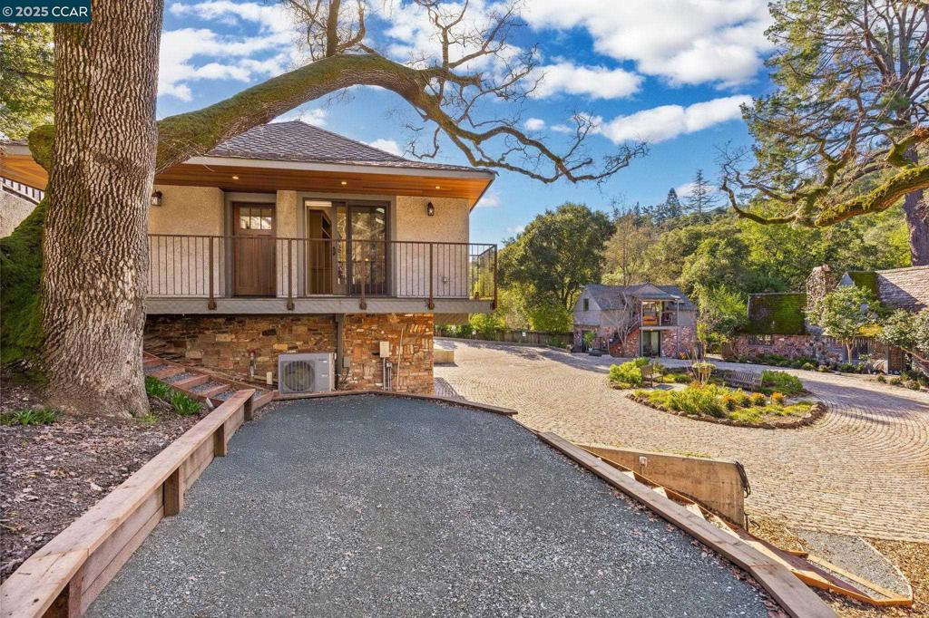 100 Moraga Way Orinda, CA 94563 - Photo 13 of 48 a front view of a house with a garden and yard