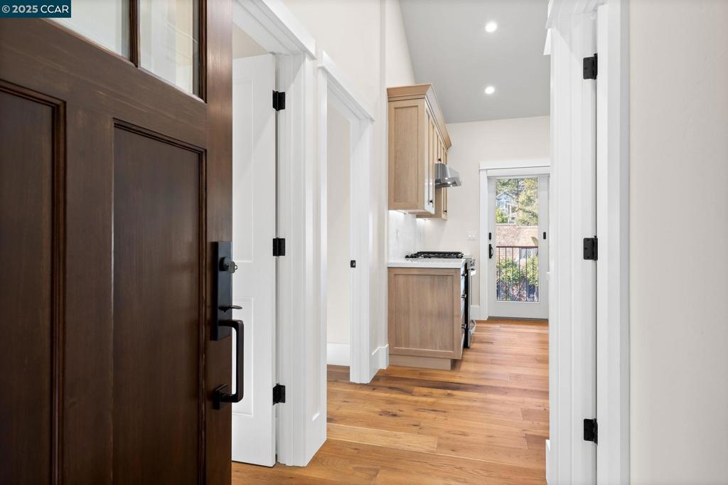 100 Moraga Way Orinda, CA 94563 - Photo 22 of 48 a view of a hallway with wooden floor windows and a room