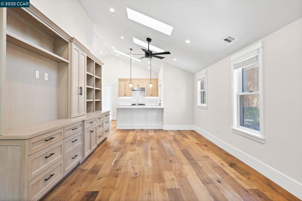 100 Moraga Way Orinda, CA 94563 - Photo 27 of 48 a open kitchen with granite countertop a refrigerator oven a sink dishwasher and white cabinets with wooden floor