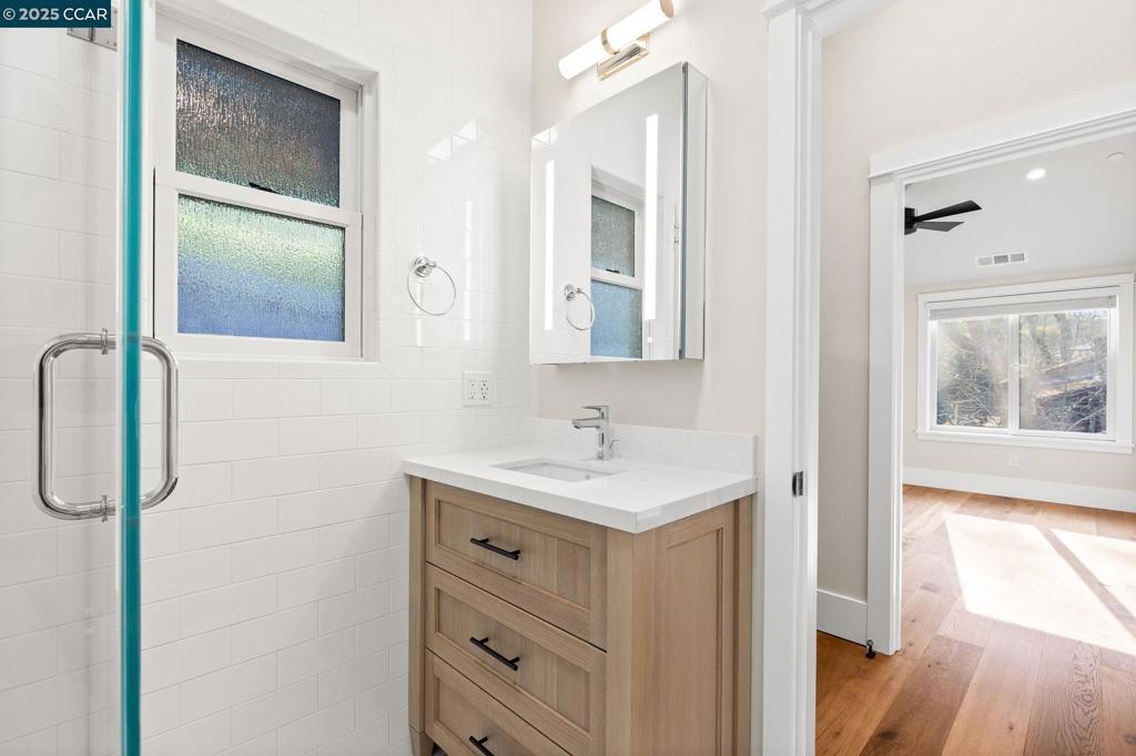 100 Moraga Way Orinda, CA 94563 - Photo 30 of 48 a bathroom with a sink a mirror and a shower