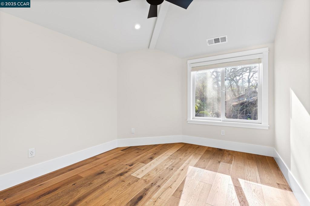 100 Moraga Way Orinda, CA 94563 - Photo 39 of 48 an empty room with wooden floor and windows