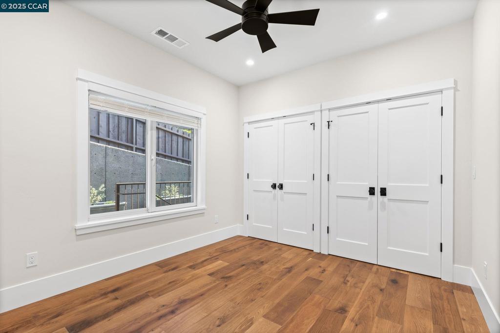 100 Moraga Way Orinda, CA 94563 - Photo 42 of 48 a view of an empty room with a window and wooden floor