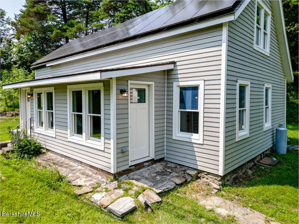 a view of a house with yard and chair