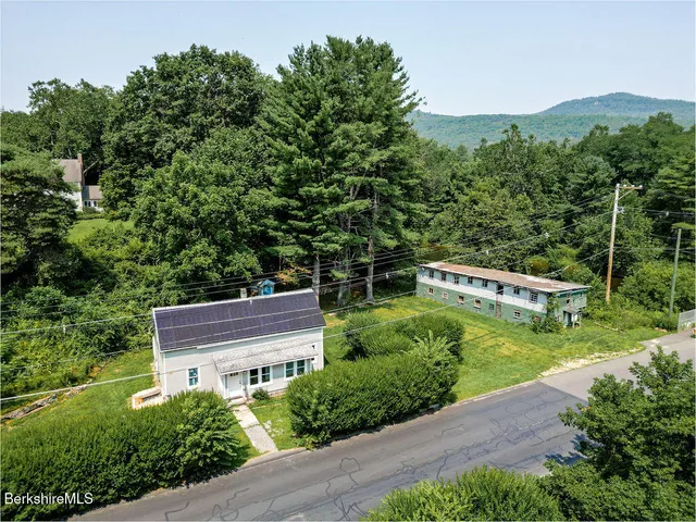 an aerial view of a house with a yard