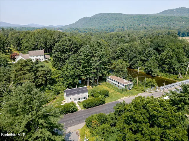 a view of a big room with windows and chandelier