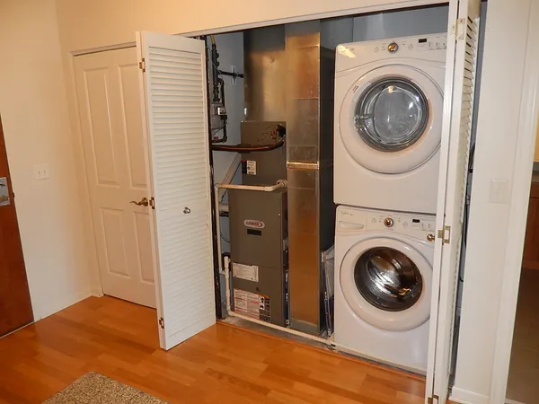 a view of a bedroom with washer and dryer