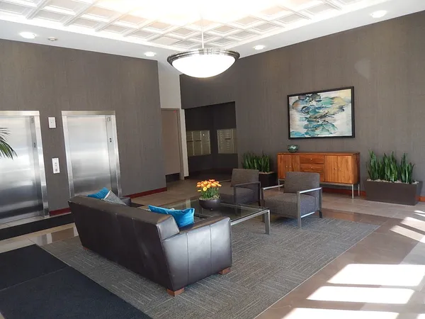 a living room with furniture and a chandelier