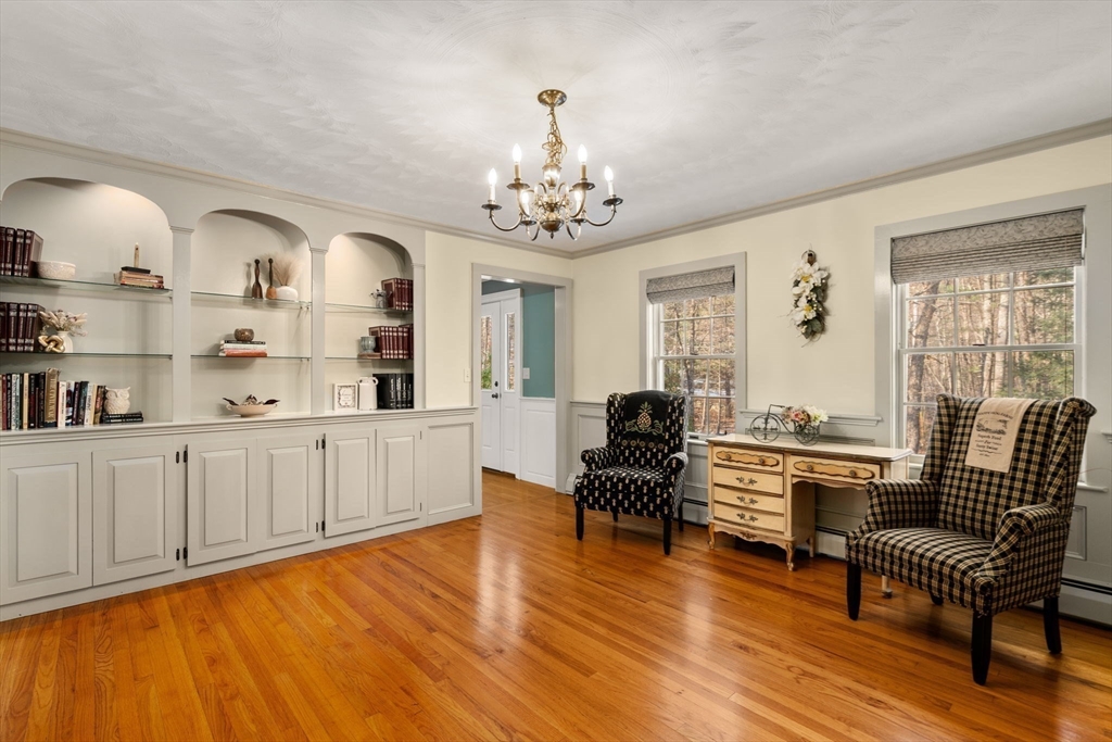 62 Allen Road Sturbridge, MA 01566 - Photo 15 of 41 a living room with kitchen island furniture and a chandelier