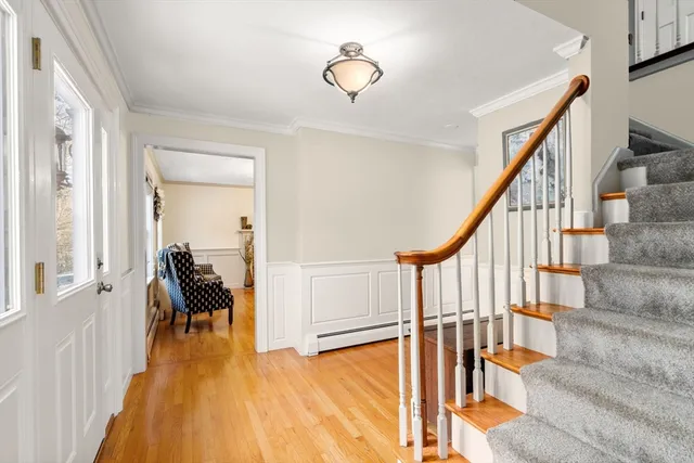 a view of a hallway with wooden floor and staircase