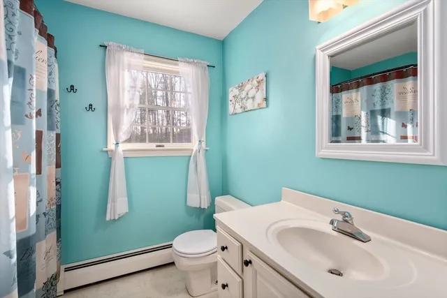 a bathroom with sink toilet and green walls