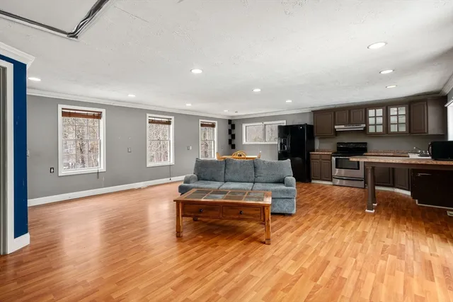 a living room with furniture and a wooden floor