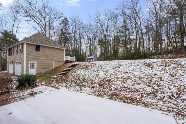 a view of a house with a yard covered in snow