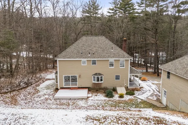 a view of a house with a yard covered in snow