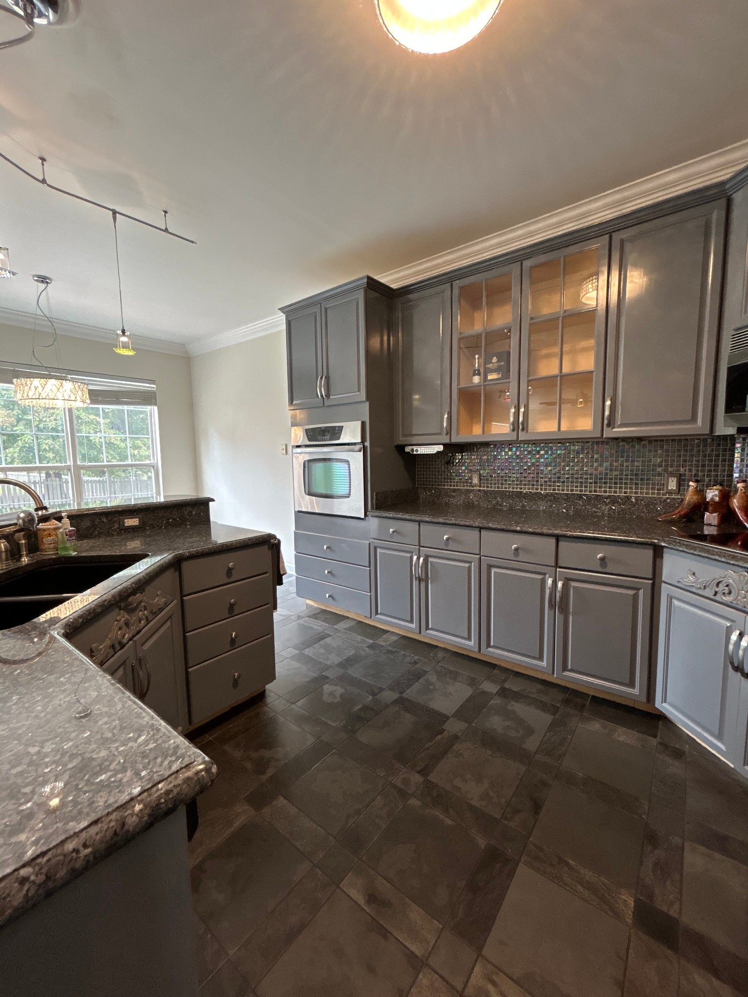 322 Logans Circle Franklin, TN 37067 - Photo 6 of 27 a kitchen with stainless steel appliances granite countertop a stove a sink and a microwave