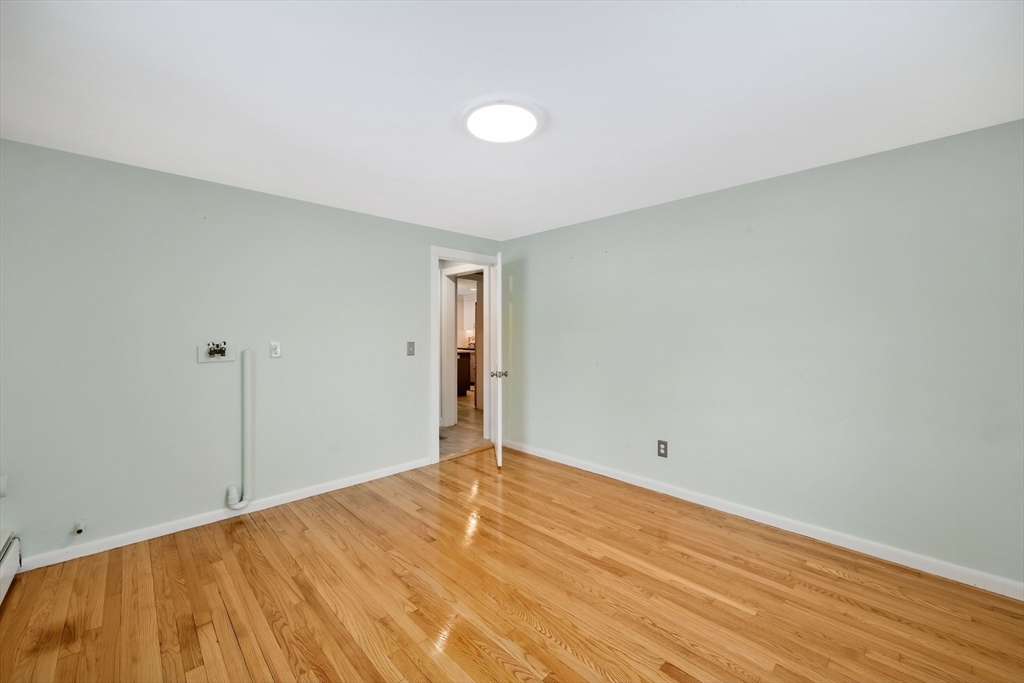 6 Cornwall Street Springfield, MA 01104 - Photo 16 of 40 a view of empty room with wooden floor