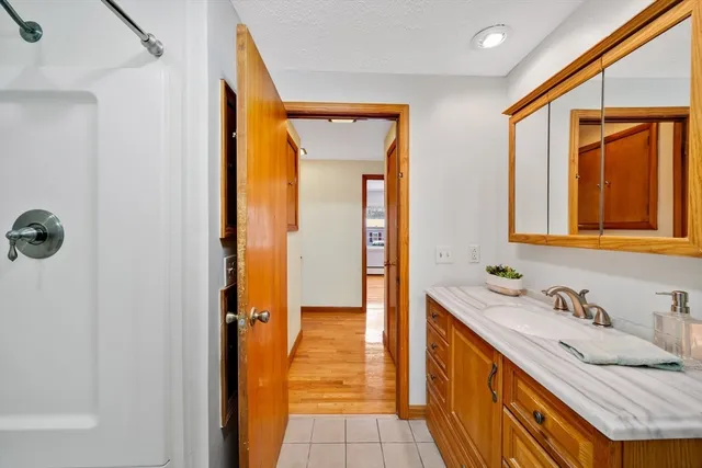 a bathroom with a granite countertop sink and a mirror