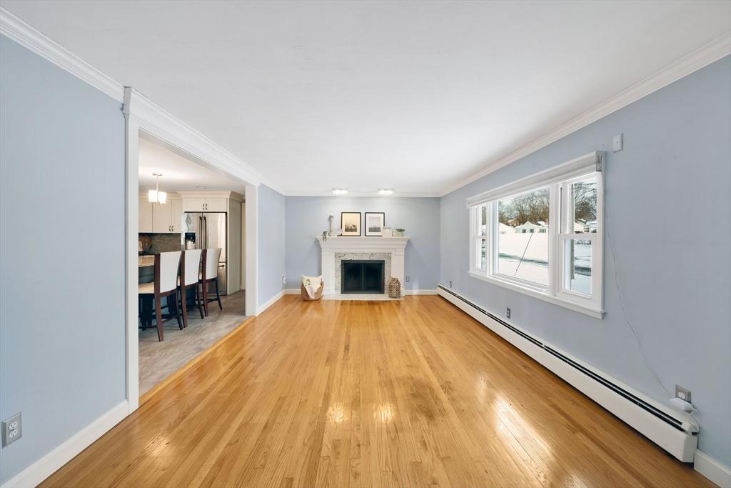 6 Cornwall Street Springfield, MA 01104 - Photo 3 of 40 a view of empty room with wooden floor and fireplace