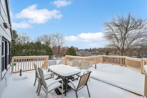 a view of a roof deck with furniture