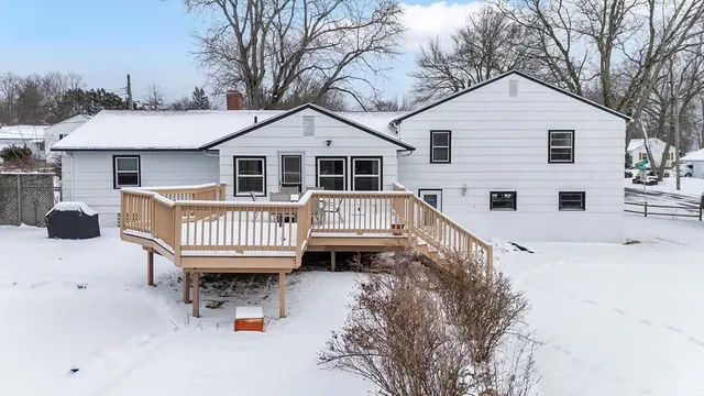a view of a house with a wooden deck
