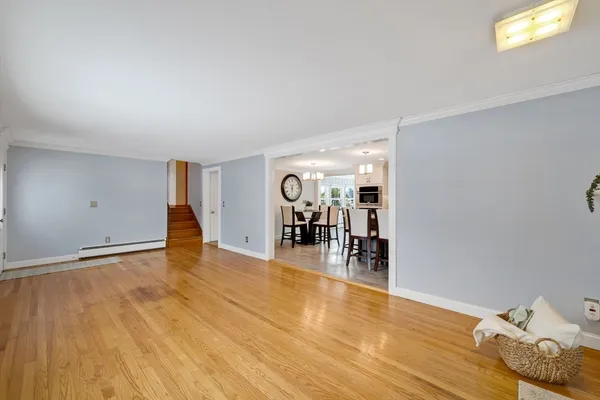 a view of a livingroom with wooden floor and a flat screen tv