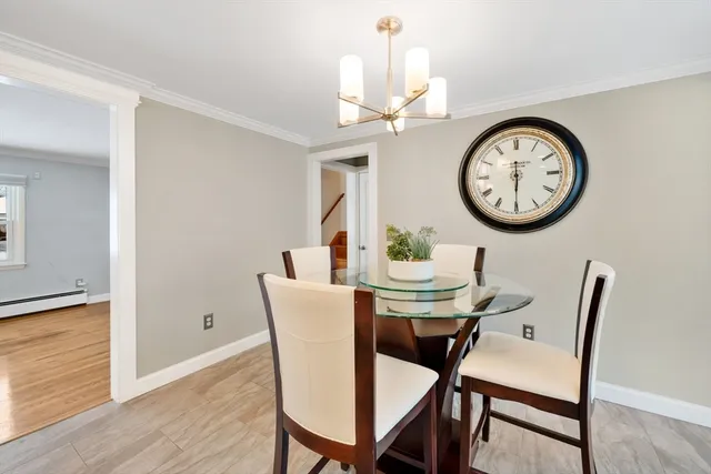 a view of a dining area with furniture and a clock