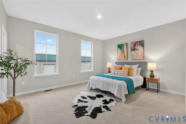 a bedroom with a bed and a potted plant