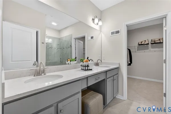 a bathroom with a sink double vanity and a mirror