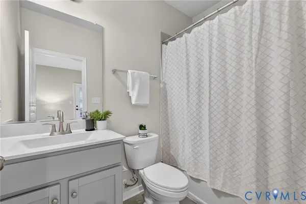 a bathroom with a toilet a sink and a mirror