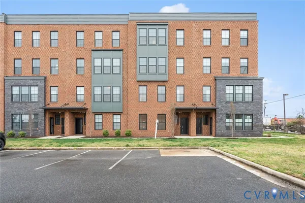 a view of a brick building next to a yard