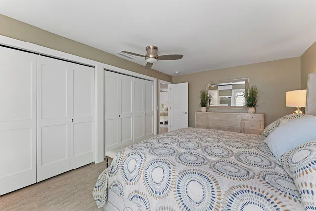 a bedroom with a large bed and a chandelier