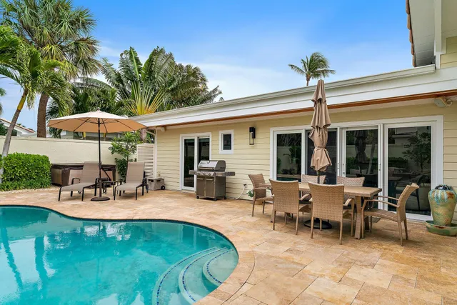 a view of a dinning table and chairs in patio of the house