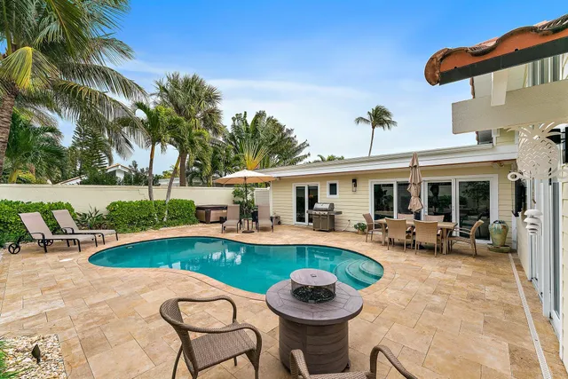 a view of a house with swimming pool and sitting area