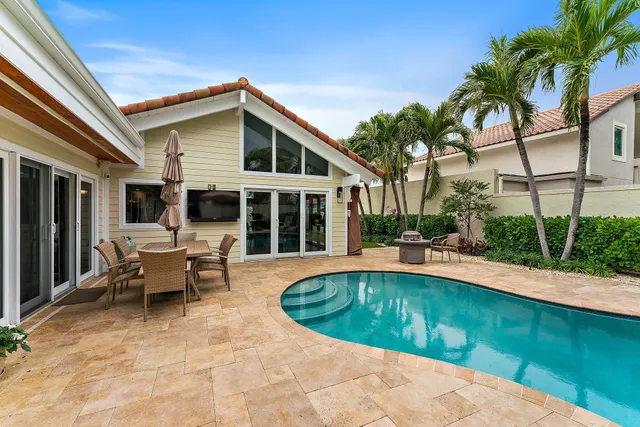 a view of a house with swimming pool and sitting area