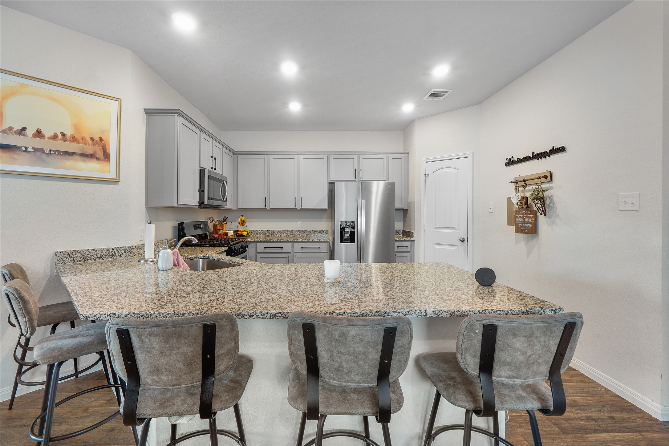 217 Evergreen Sumac Loop Kyle, TX 78640 - Photo 5 of 20 Culinary aspirations meet contemporary design in this well-appointed kitchen, featuring ample counter space and integrated appliances.