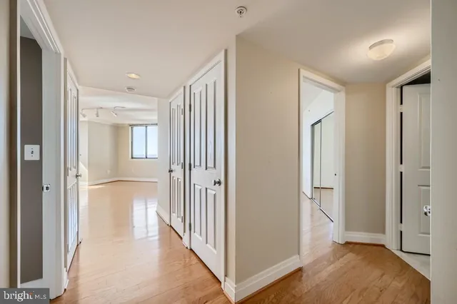 a view of a hallway with wooden floor and entryway