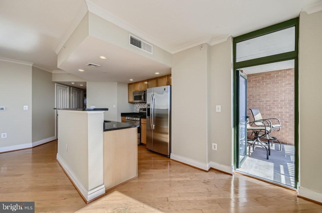 414 Water Street, Unit 2814 Baltimore, MD 21202 - Photo 8 of 28 a view of a kitchen with refrigerator and wooden floor