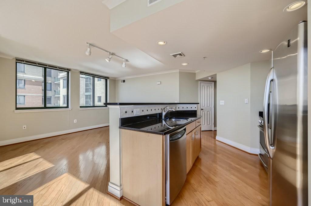 414 Water Street, Unit 2814 Baltimore, MD 21202 - Photo 9 of 28 a kitchen with stainless steel appliances granite countertop a sink and a refrigerator