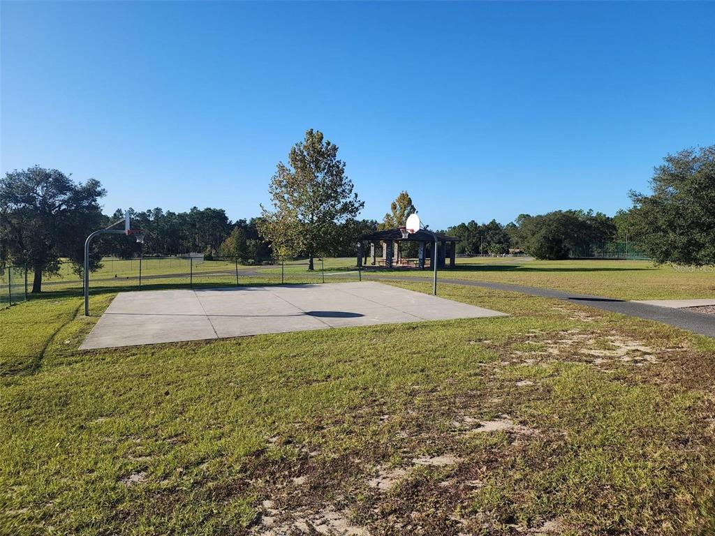 649 Southwest Winding Hills Road Dunnellon, FL 34431 - Photo 19 of 26 a view of a swimming pool with an outdoor space and seating area